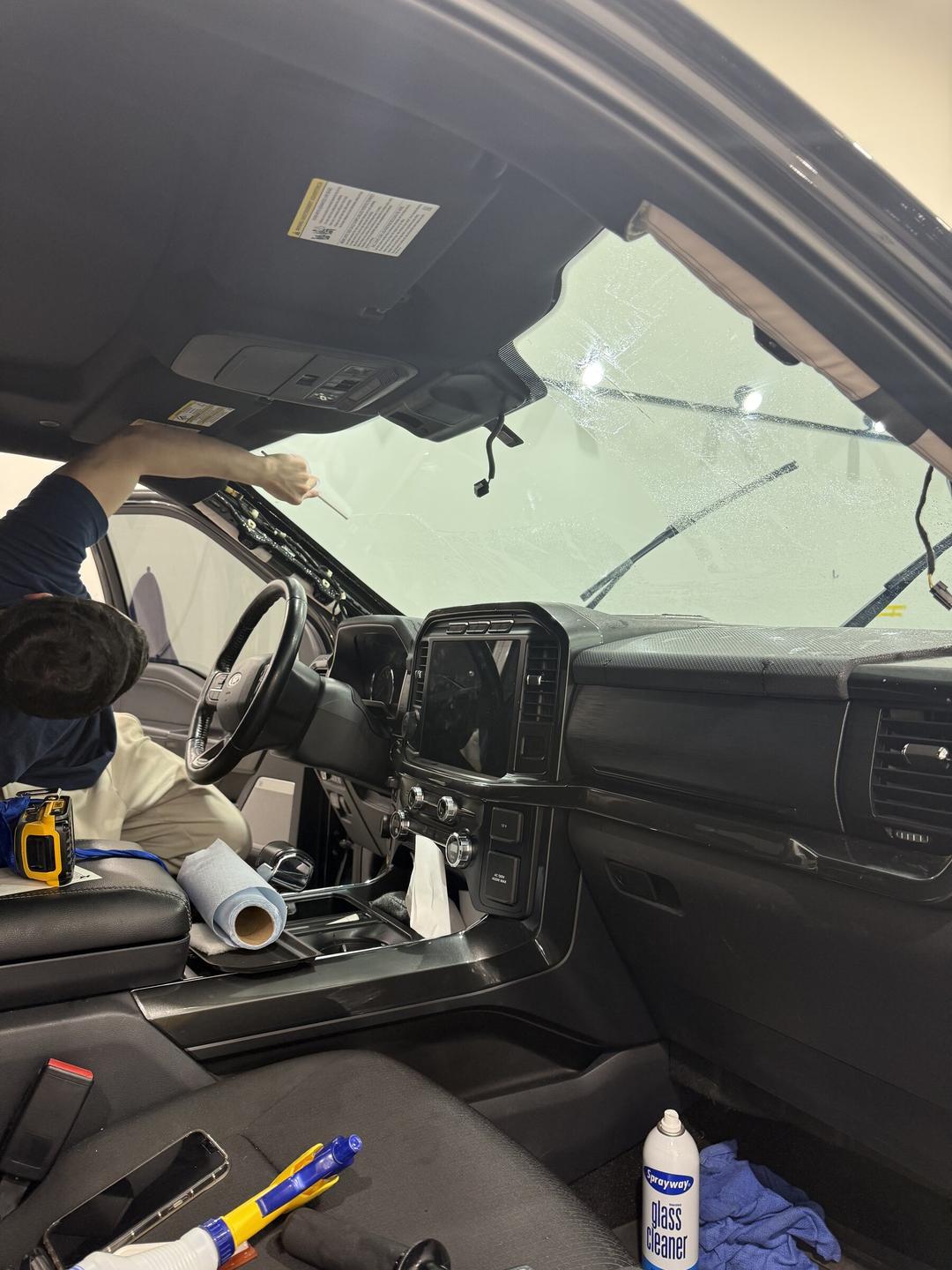 Ceramic windshield film being squeegeed from inside a truck at Taggart Films